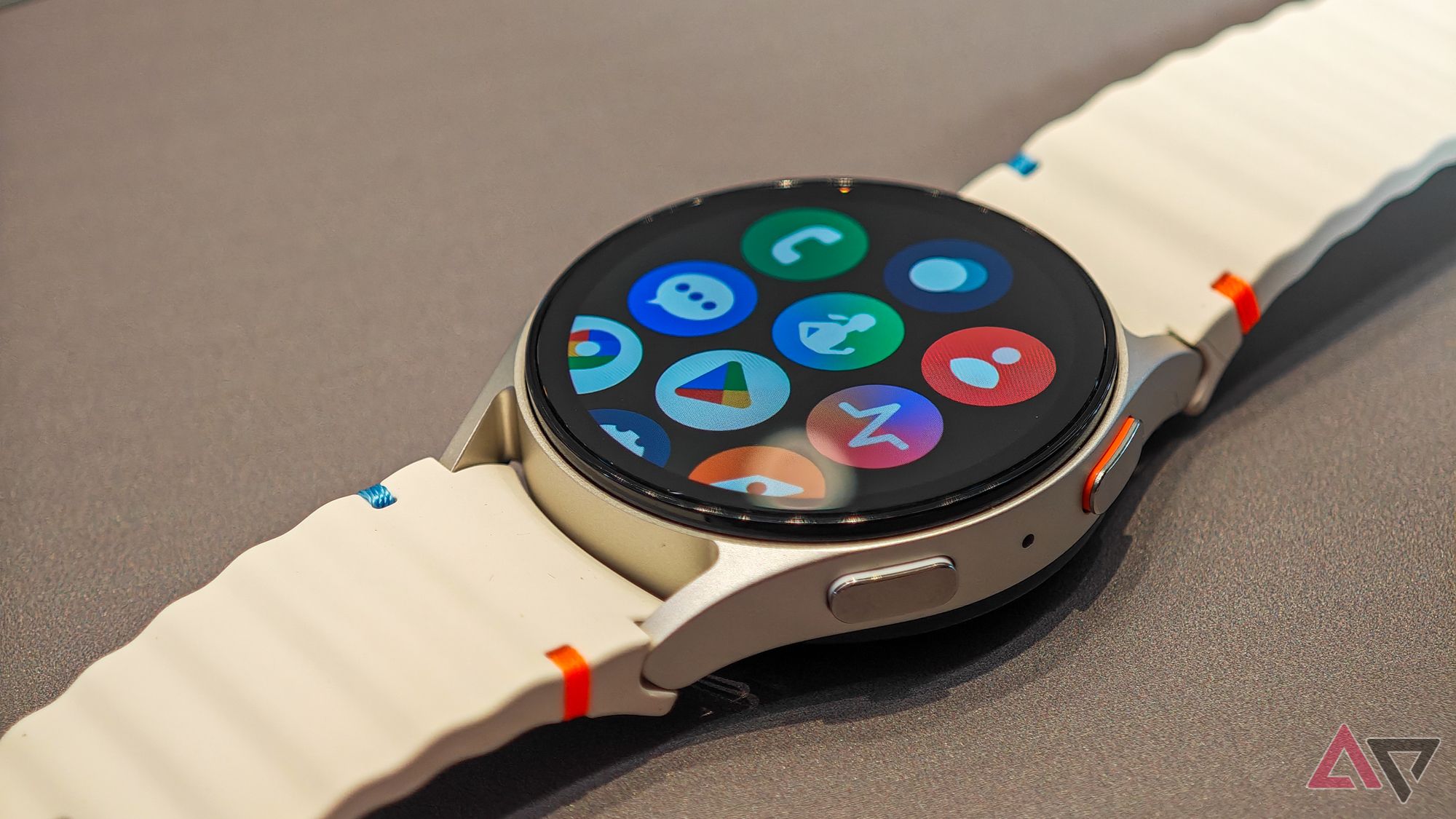 Samsung Galaxy Watch 7 is white on a dark flat surface