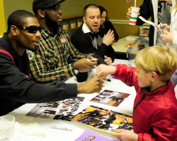 Pylesville's Matthew Wilson, right, gives Baltimore Ravens player Jacoby ...