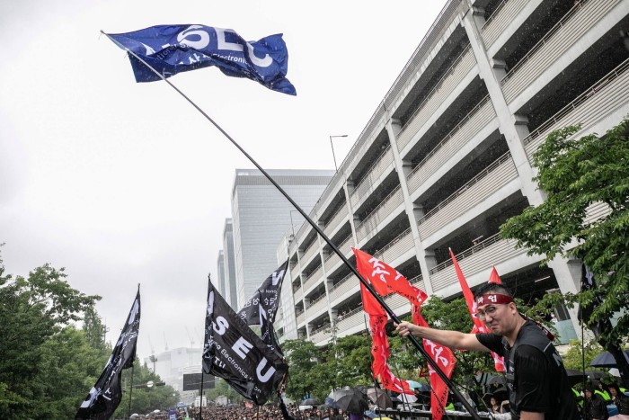 UN members wave flags outside the Samsung plant during the strike 