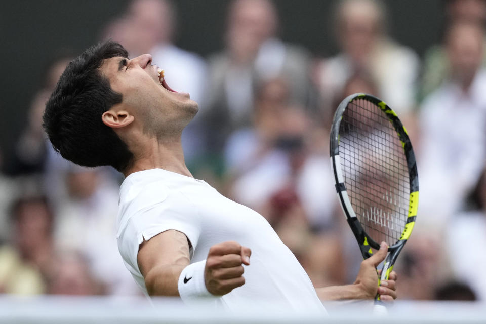 Spain's Carlos Alcaraz celebrates after defeating Russia's Daniil Medvedev in their Wimbledon tennis tournament final in London, Friday, July 12, 2024. (AP Photo/Mosa'ab Elshamy)